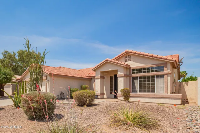 a front view of a house with a yard outdoor seating and barbeque oven