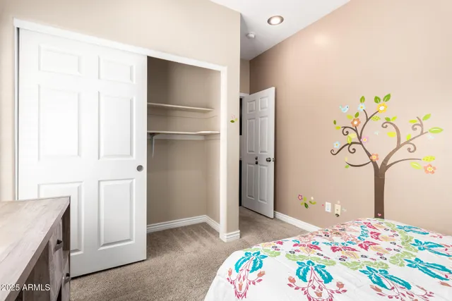 a bedroom with a bed and a dresser