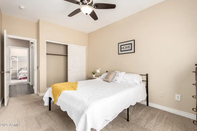 a bedroom with a bed and a chandelier