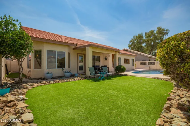 a front view of house with a garden
