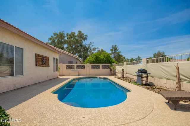 a view of a swimming pool with a lounge chair
