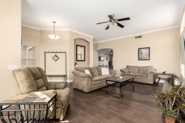 a living room with furniture and a chandelier