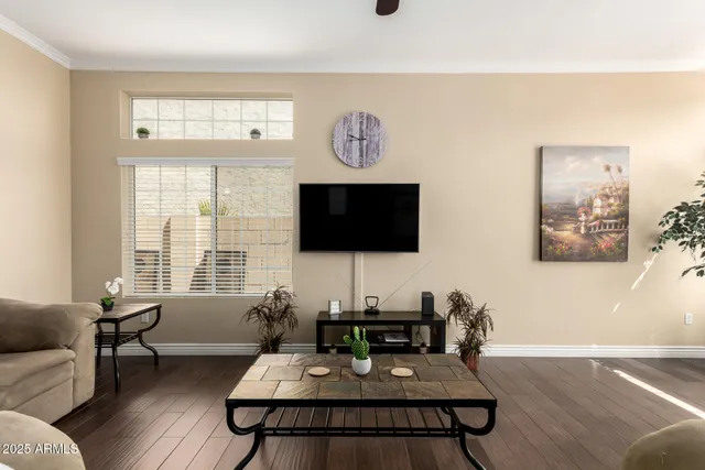 a living room with furniture a flat screen tv and a large window