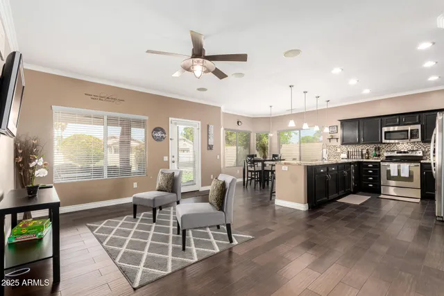 a living room with furniture a flat screen tv and a large window