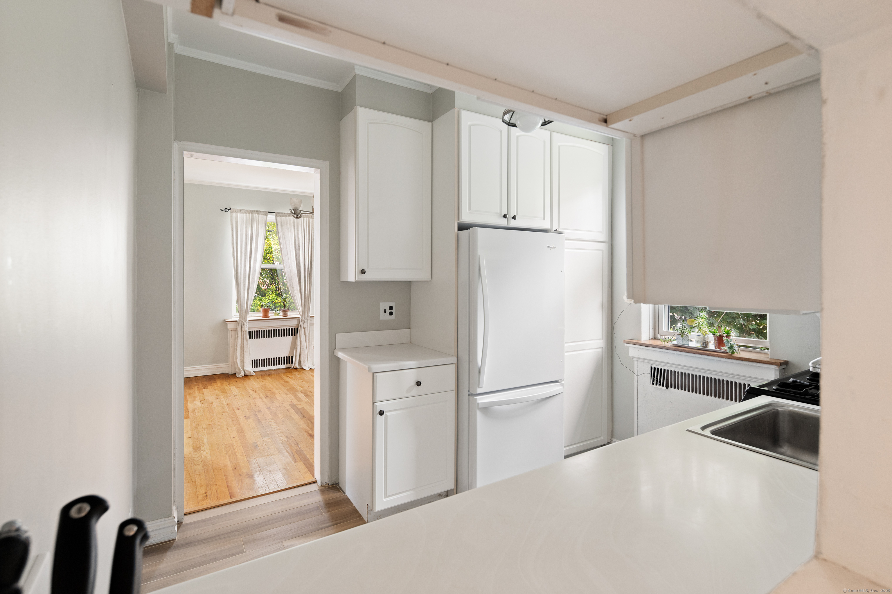 70 Strawberry Hill Avenue, Unit 22D Stamford, CT 06902 - Photo 18 of 39 a kitchen with white cabinets and refrigerator