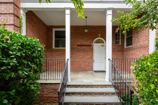 a view of a house with a door and a potted plant