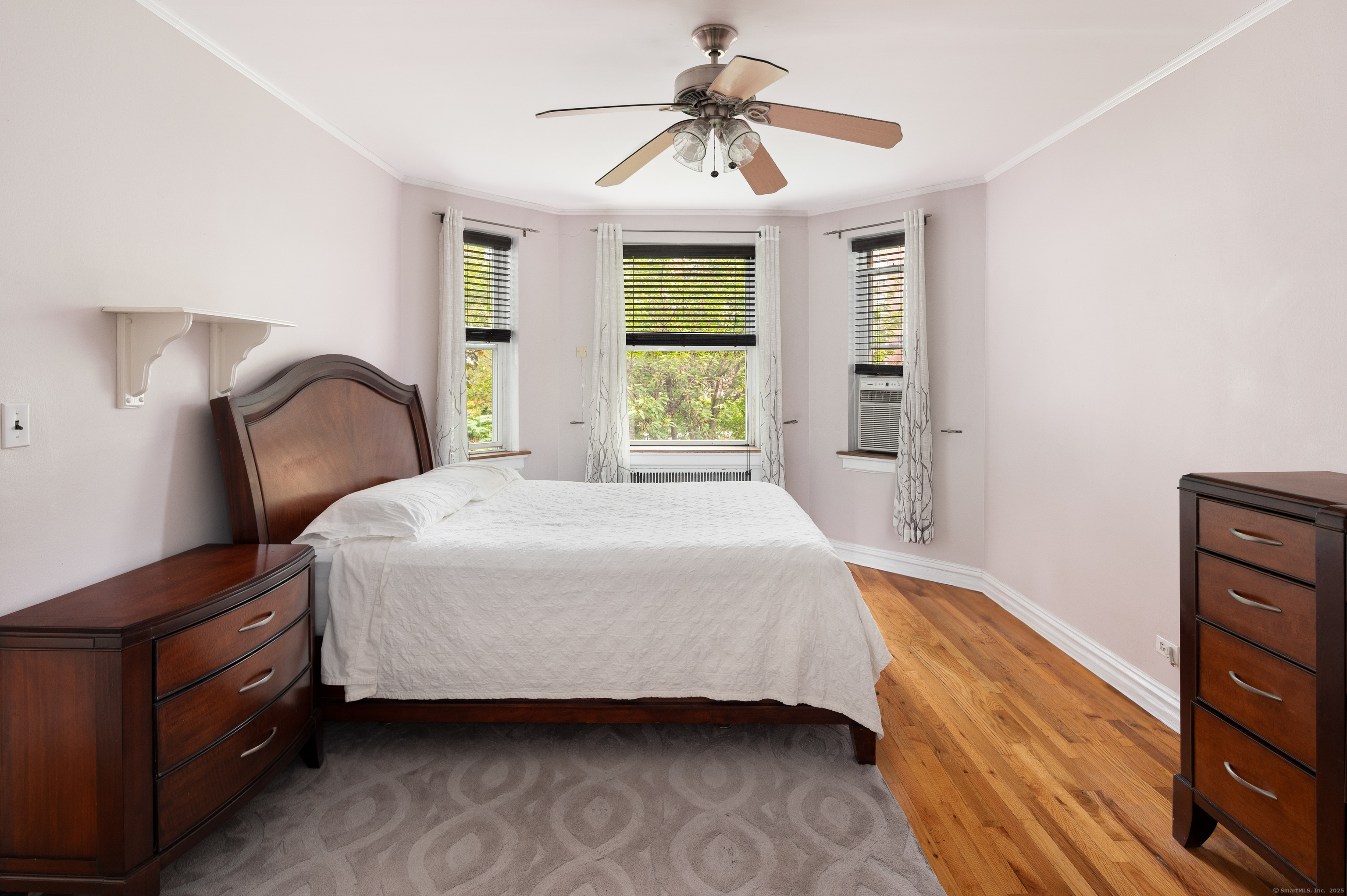70 Strawberry Hill Avenue, Unit 22D Stamford, CT 06902 - Photo 23 of 39 a bedroom with a bed chandelier and a window