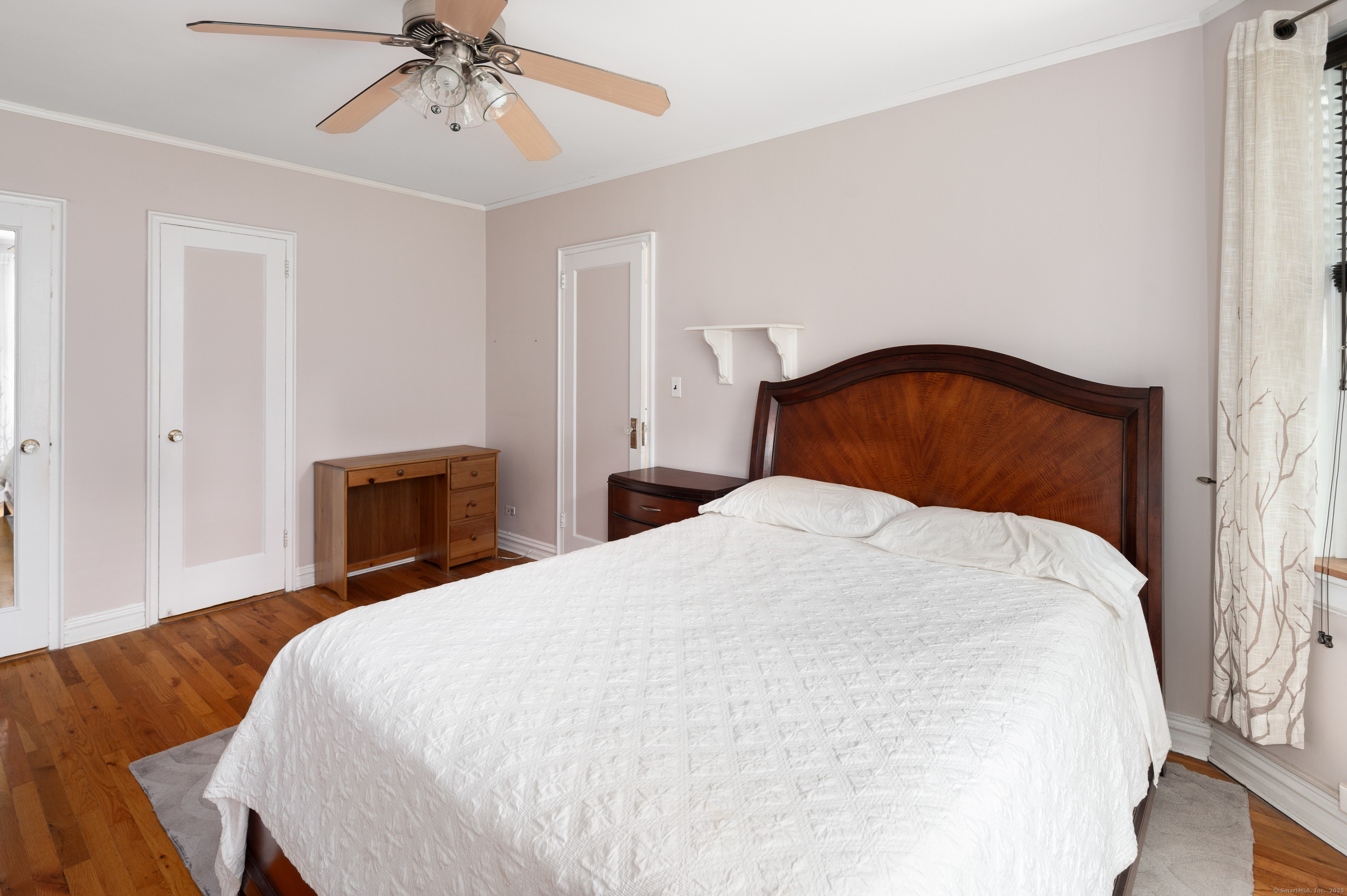 70 Strawberry Hill Avenue, Unit 22D Stamford, CT 06902 - Photo 24 of 39 a bedroom with a bed and a chandelier