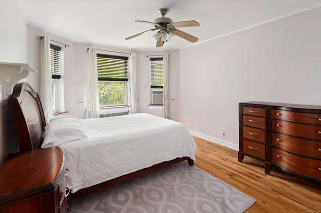 a bedroom with a bed dresser and a window