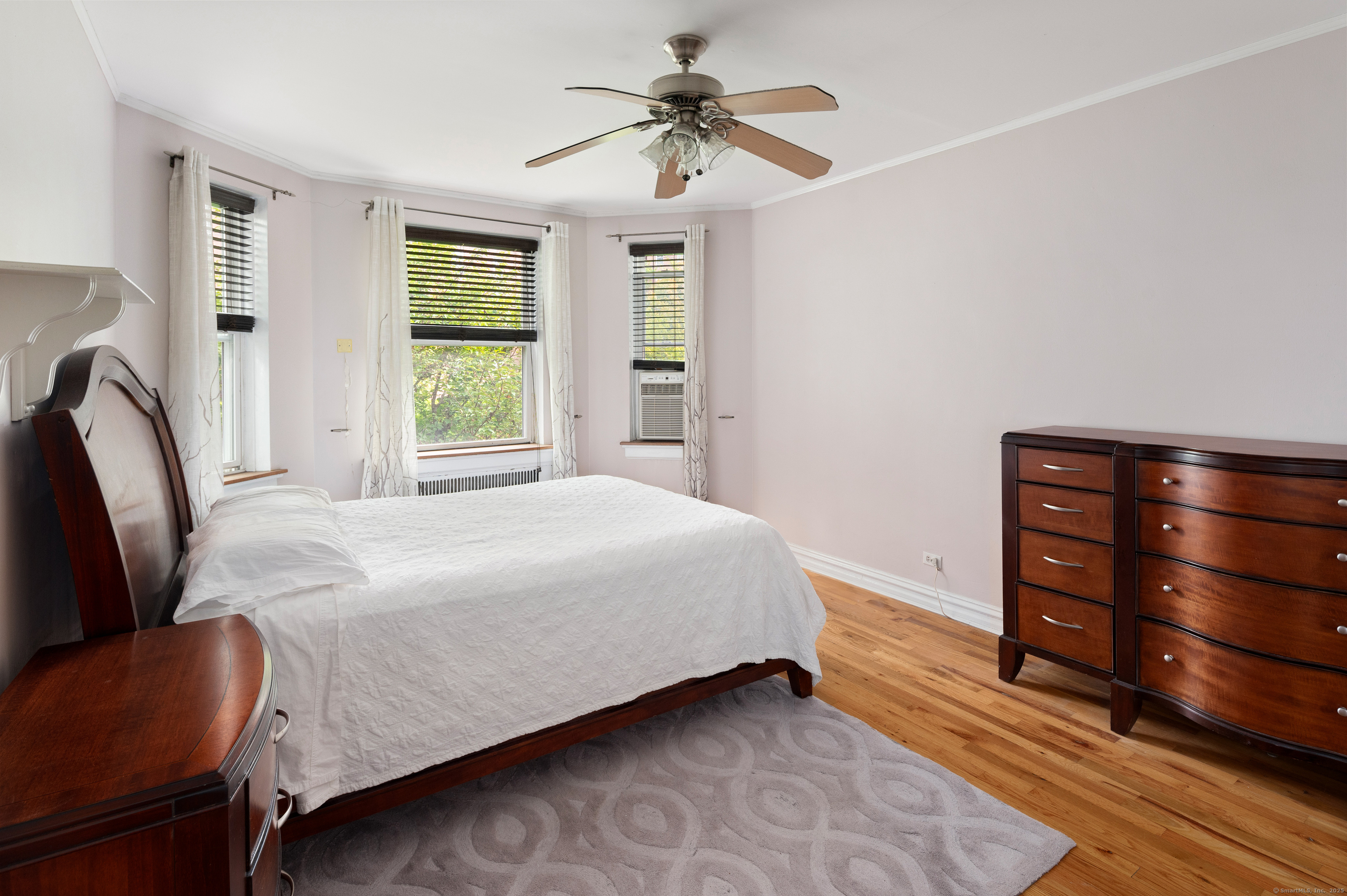 70 Strawberry Hill Avenue, Unit 22D Stamford, CT 06902 - Photo 25 of 39 a bedroom with a bed dresser and a window