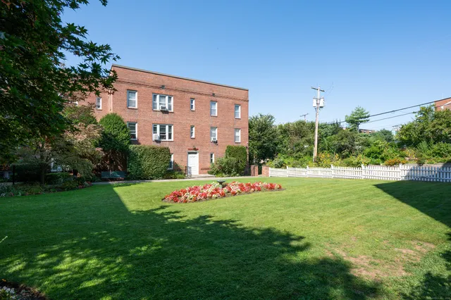 a view of a house with a yard table and chairs