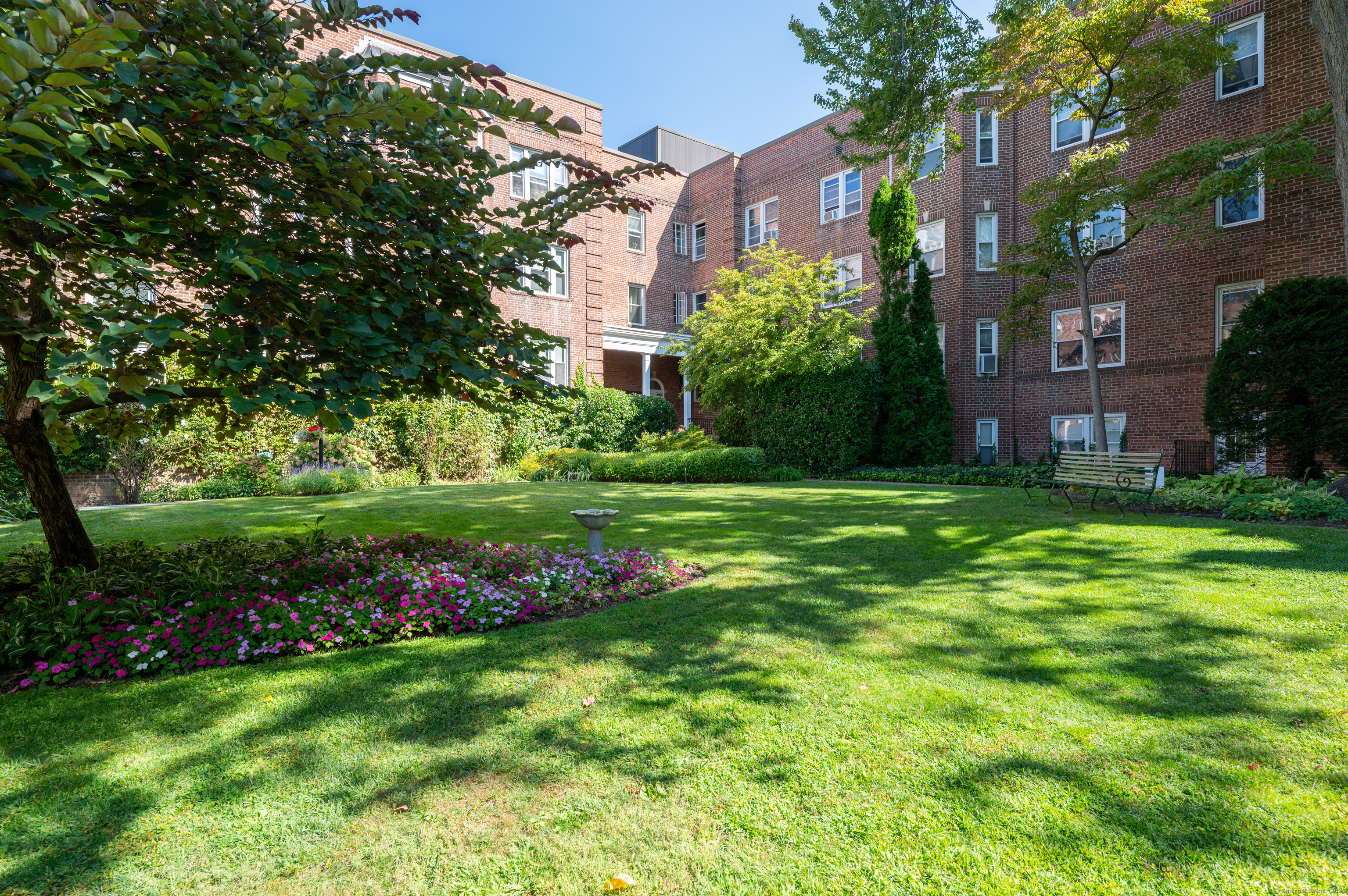 70 Strawberry Hill Avenue, Unit 22D Stamford, CT 06902 - Photo 30 of 39 a view of a green field with plants and trees in the background