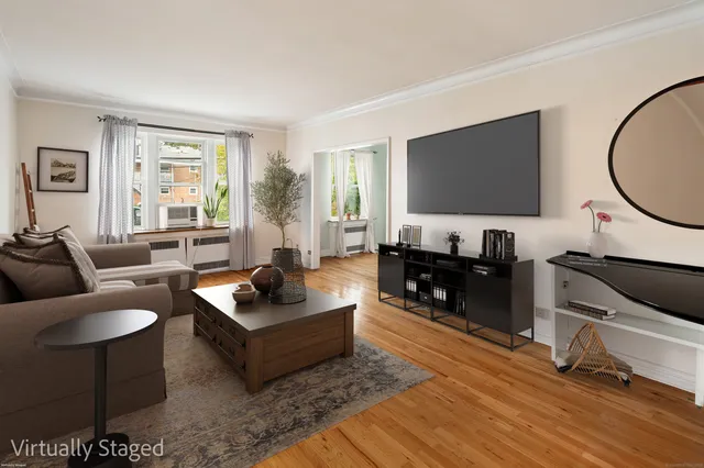 a living room with furniture and a flat screen tv with wooden floor