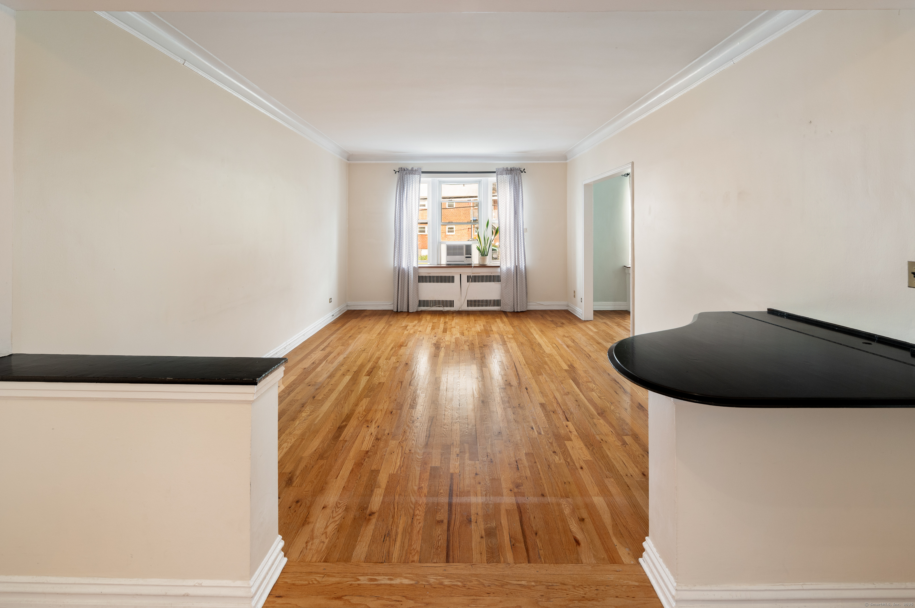 70 Strawberry Hill Avenue, Unit 22D Stamford, CT 06902 - Photo 7 of 39 a view of a livingroom with wooden floor and staircase
