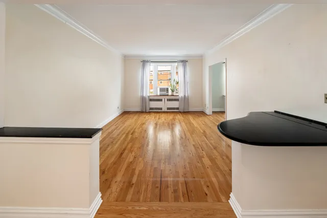 a view of a livingroom with wooden floor and staircase