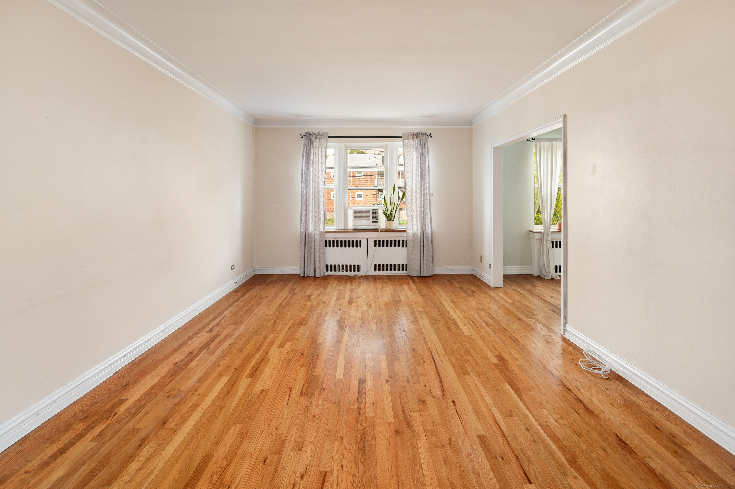 70 Strawberry Hill Avenue, Unit 22D Stamford, CT 06902 - Photo 9 of 39 an empty room with wooden floor and windows