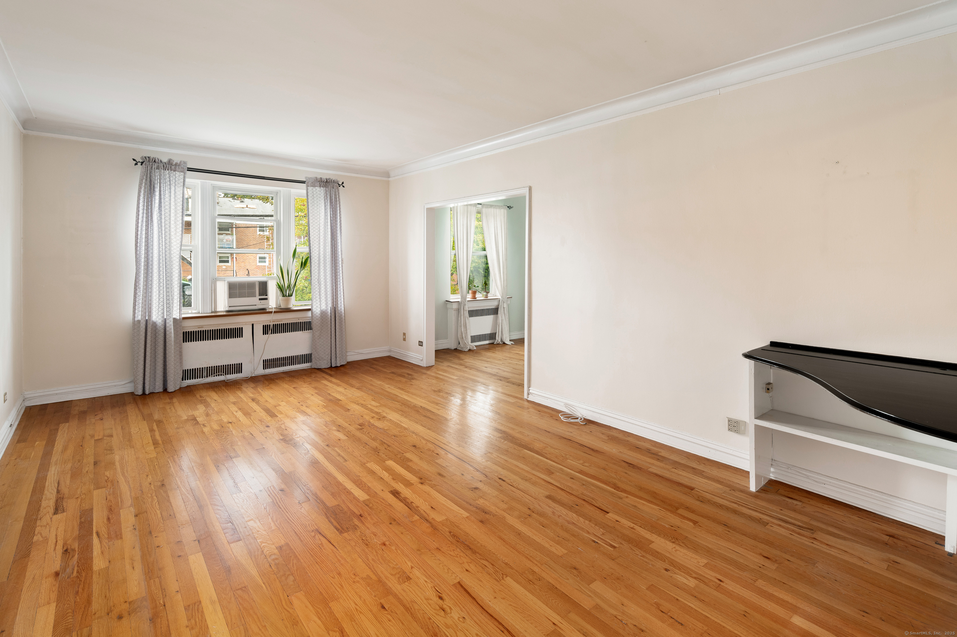 70 Strawberry Hill Avenue, Unit 22D Stamford, CT 06902 - Photo 10 of 39 an empty room with wooden floor and windows
