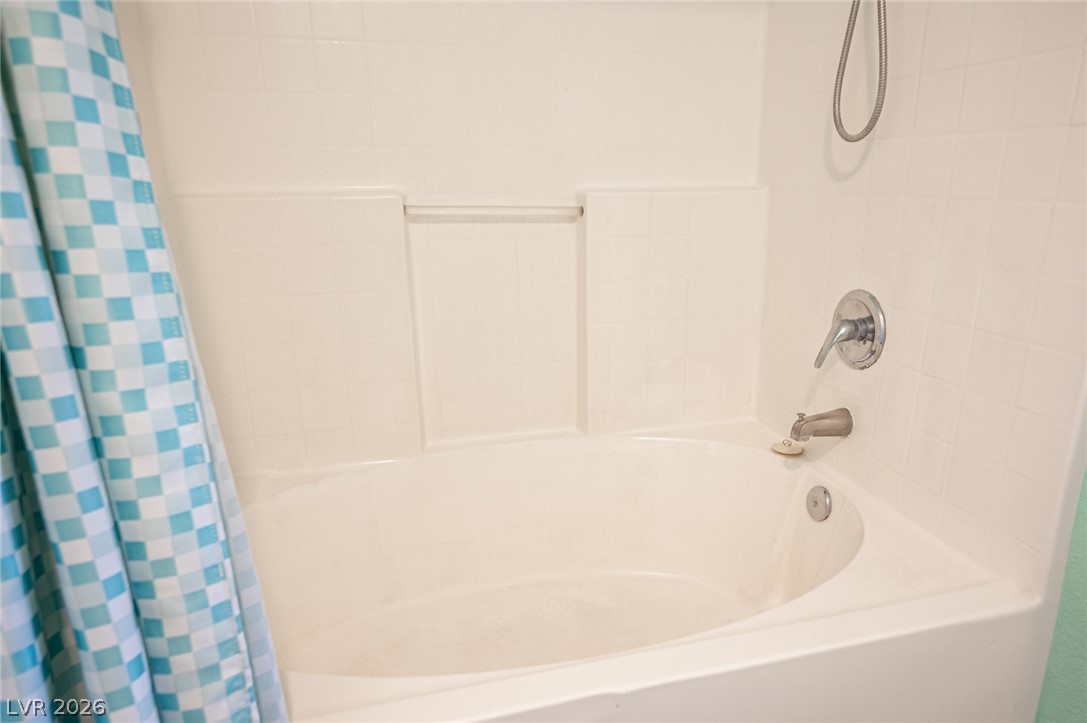 10550 West Alexander Road, Unit 2014 Las Vegas, NV 89129 - Photo 28 of 35 Relax and rejuvenate in this bathroom's clean, functional tub with a shower head.