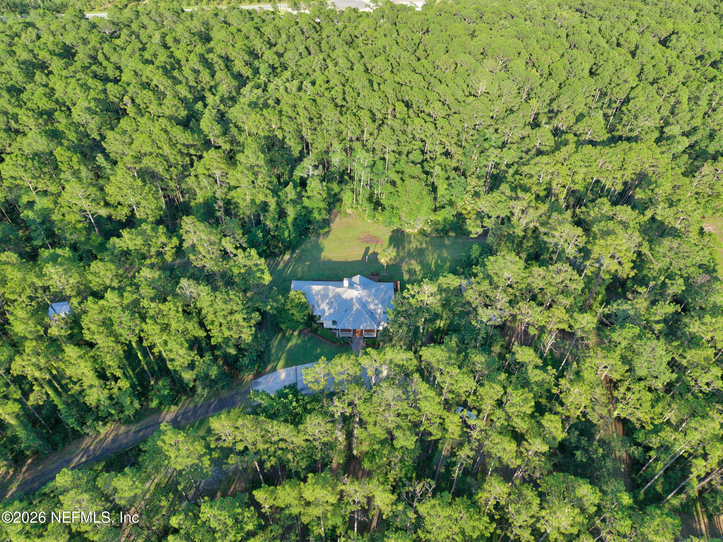 3090 Monument Bay Road St. Augustine, FL 32092 - Photo 54 of 56 a backyard of a house with a tree