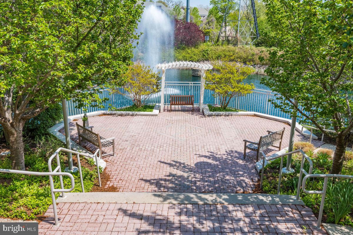 11800 Sunset Hills Road, Unit 514 Reston, VA 20190 - Photo 3 of 57 a view of a yard with plants and a bench