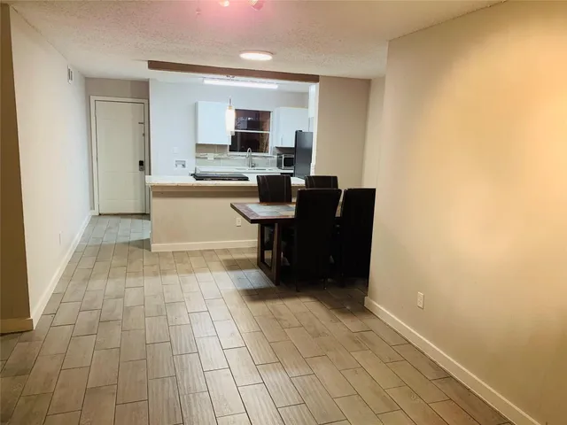 a view of kitchen with cabinets and window