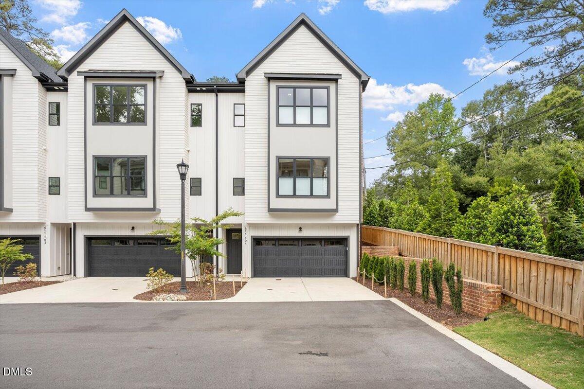 811 Maple Berry Lane, Unit 101 Raleigh, NC 27607 - Photo 1 of 45 a front view of a house with a yard