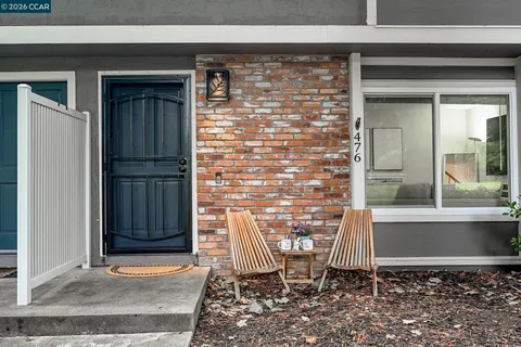 a front view of a house with outdoor seating