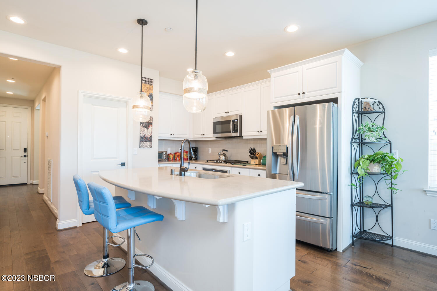 625 Agapanthus Way Santa Maria, CA 93455 - Photo 7 of 37 a kitchen with stainless steel appliances a refrigerator a sink a stove a dining table and chairs