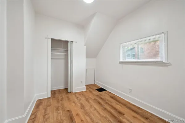 a view of a room that has a bed and a window