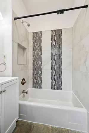 a bathroom with a bathtub and shower