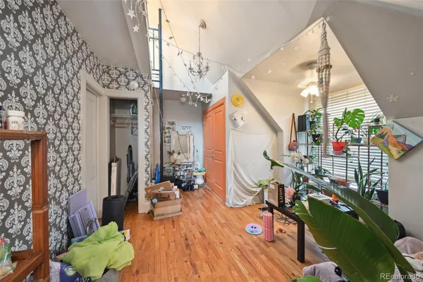 a kitchen with stainless steel appliances a sink a stove and a wooden floor