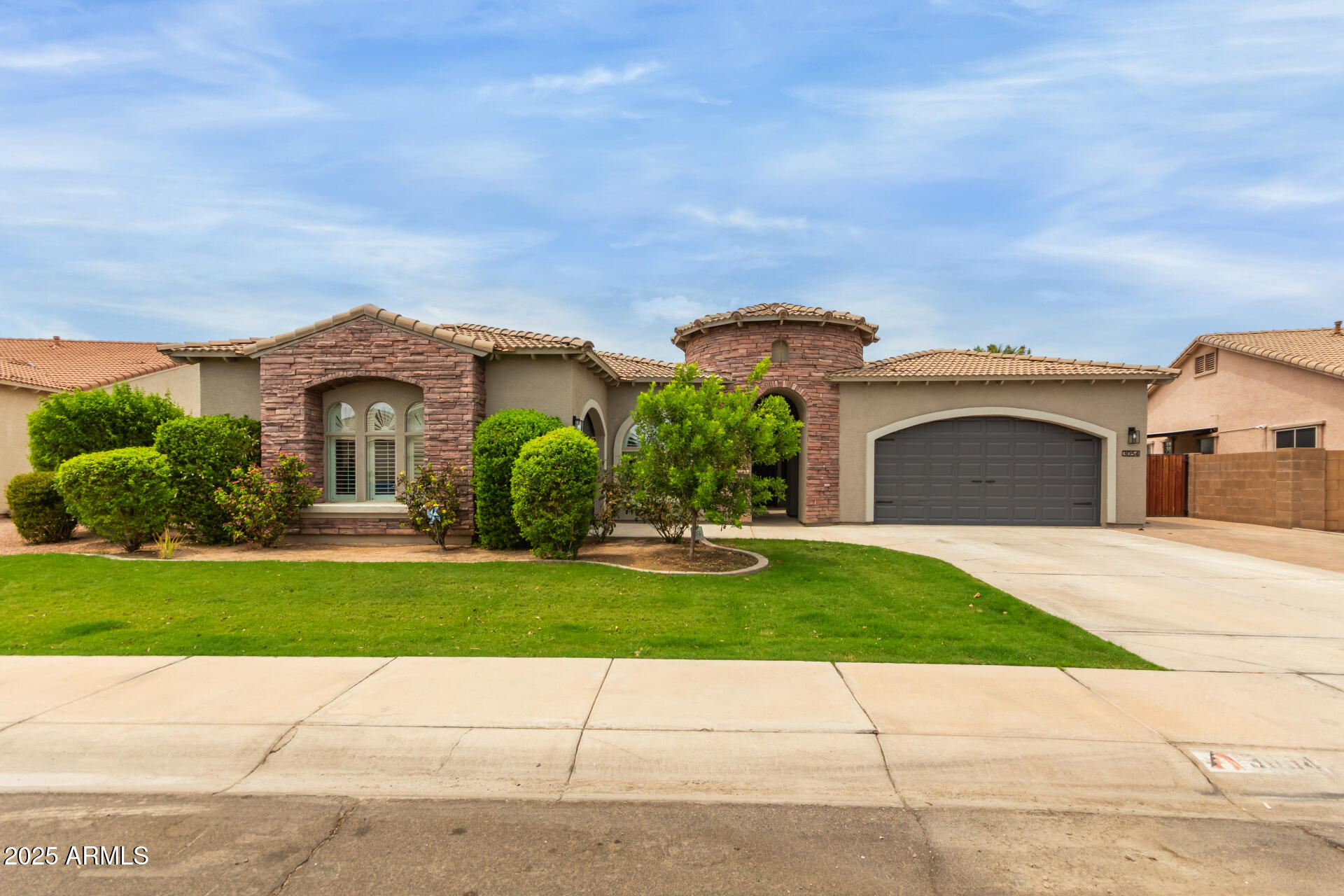3054 South Colonial Street Gilbert, AZ 85295 - Photo 1 of 29 a front view of a house with a garden and a yard