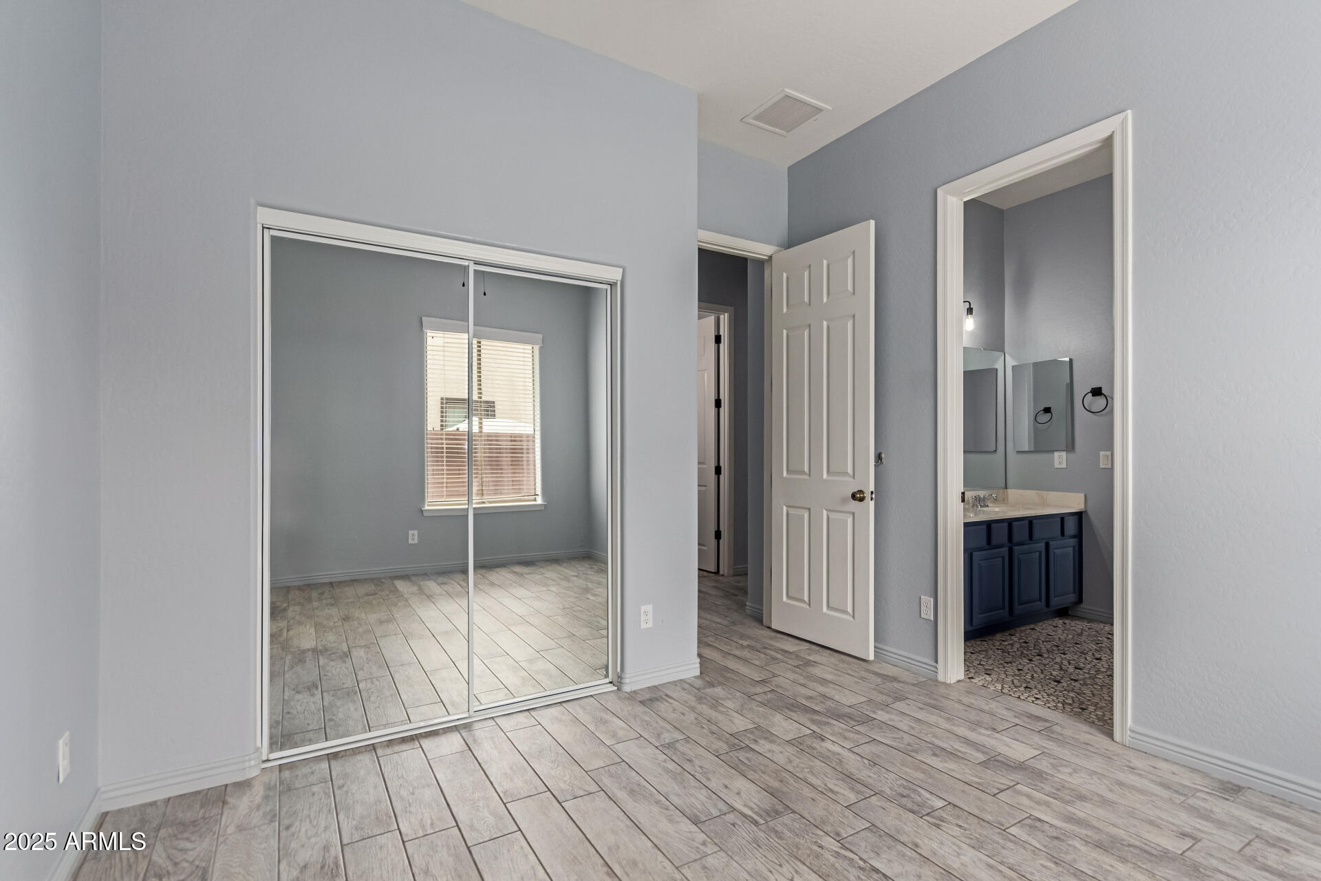 3054 South Colonial Street Gilbert, AZ 85295 - Photo 18 of 29 a view of an empty room with wooden floor and a window