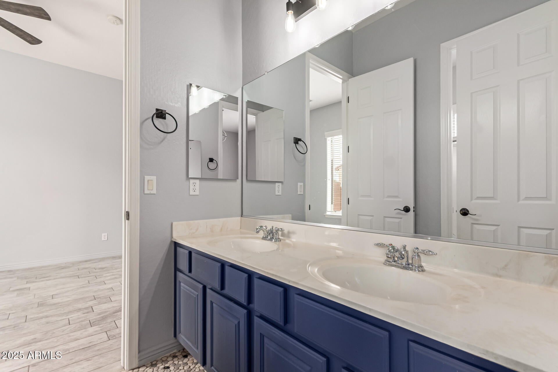 3054 South Colonial Street Gilbert, AZ 85295 - Photo 19 of 29 a bathroom with a sink and a mirror