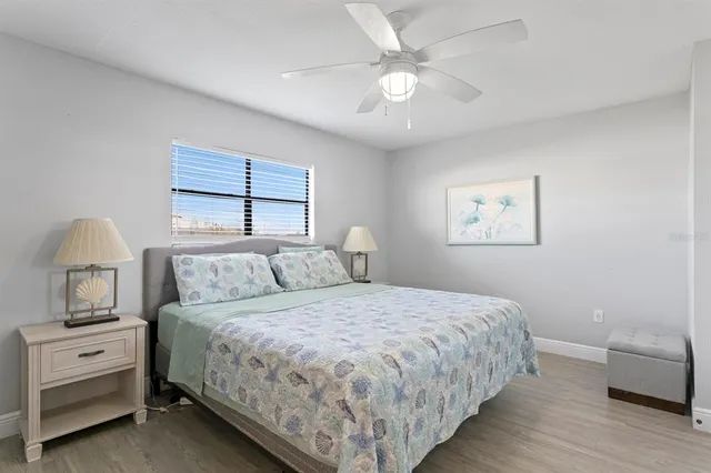 a bedroom with two beds and a chandelier