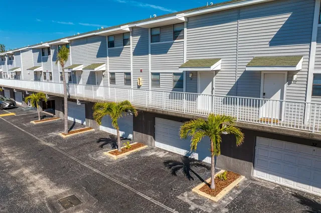 a kitchen with stainless steel appliances granite countertop a sink dishwasher stove and white cabinets with wooden floor
