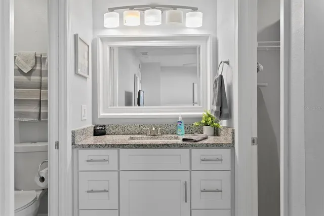 an aerial view of a city with lots of residential buildings ocean and mountain view in back