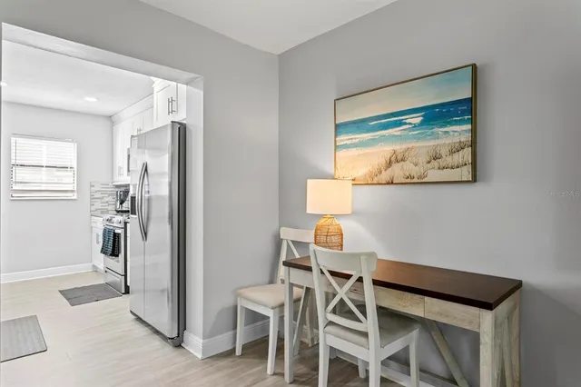 a living room with furniture a dining table and a fireplace