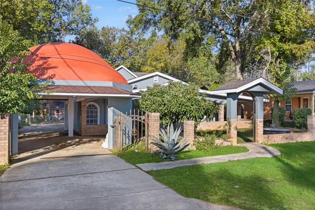 a front view of house with yard and green space