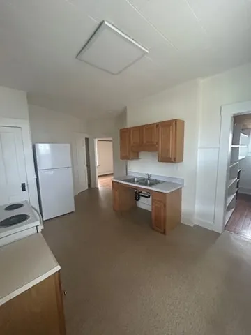 a kitchen with stainless steel appliances a refrigerator and a stove