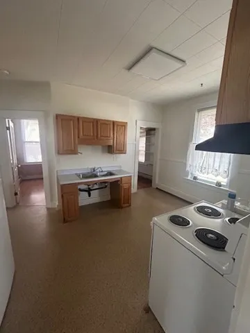 a kitchen that has a stove and a table in it