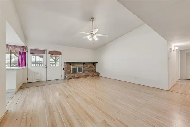 an empty room with piano and windows