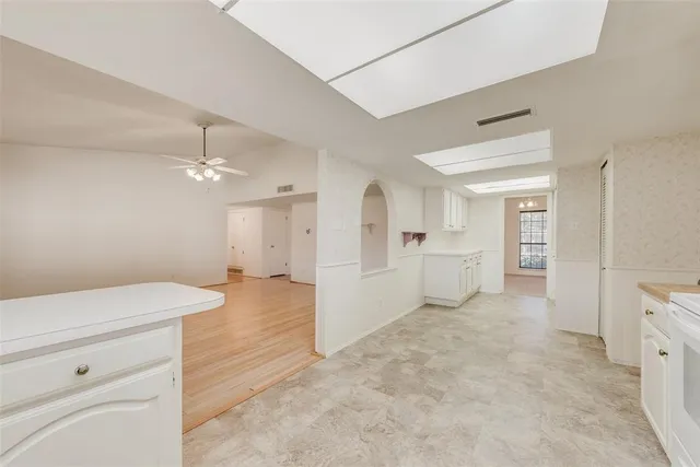 a view of a hallway with closet and chandelier