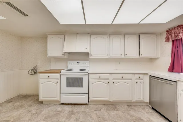 a kitchen with white cabinets