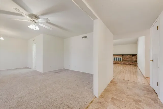 a view of a hallway with a chandelier fan