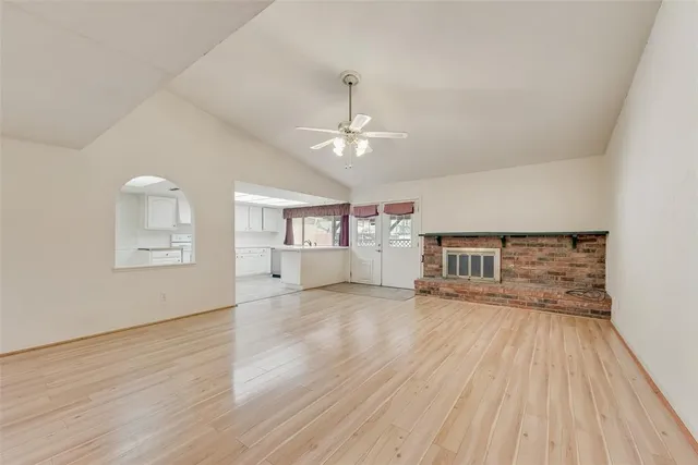 a view of a livingroom with wooden floor and a ceiling fan
