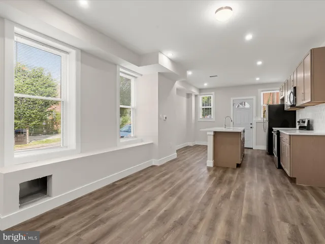 a view of kitchen with furniture and wooden floor