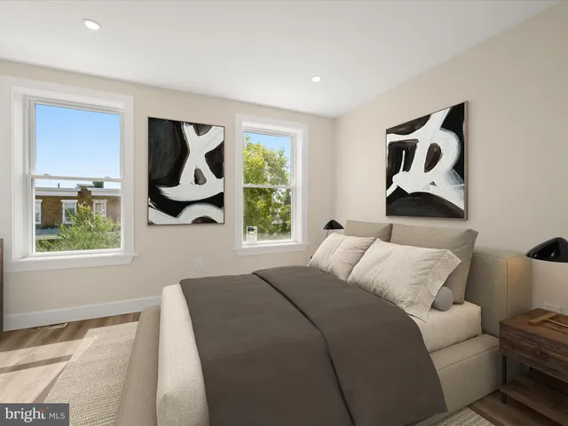 a bedroom with a bed and a painting on the wall