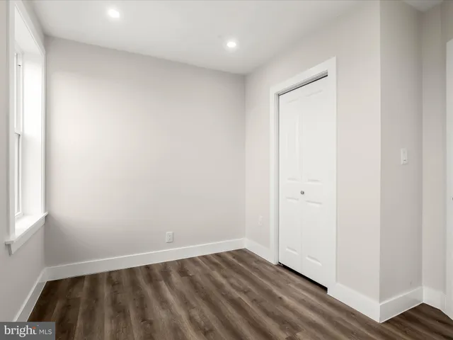 an empty room with wooden floor