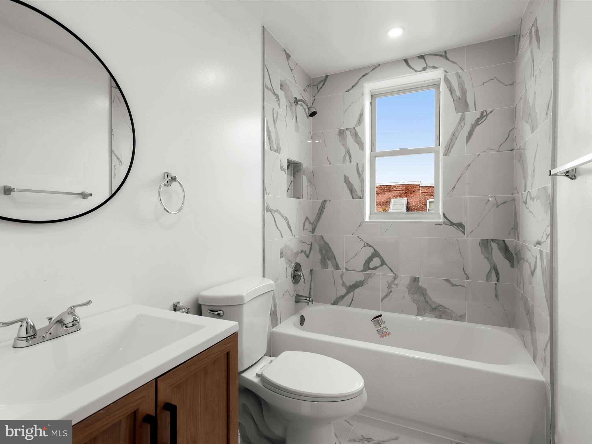 2800 East Chase Street Baltimore, MD 21213 - Photo 23 of 37 a bathroom with a sink toilet and shower